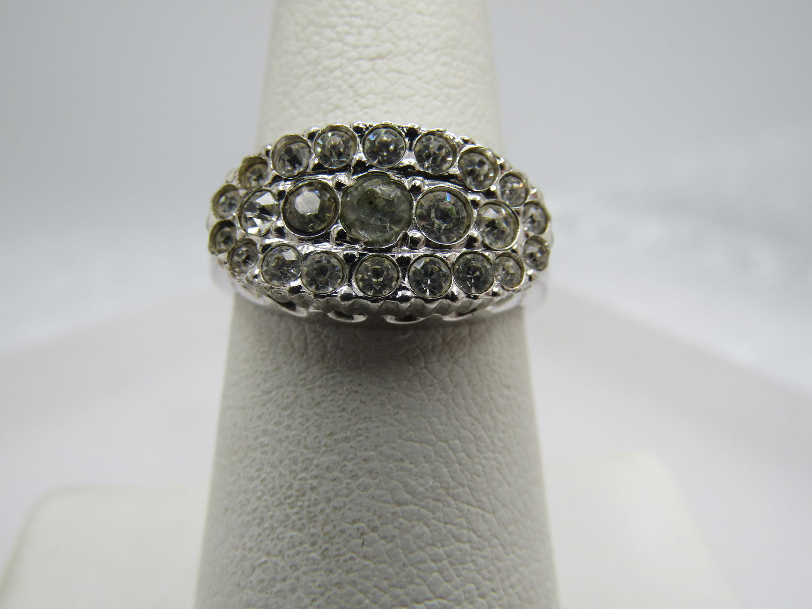 Vintage Clear Rhinestone Ring, Sz. 7.25, 1970's-1980's, Signed: Vintage Clear Rhinestone Ring, Sz. 7.25, 1970's-1980's, Signed with a mark that cannot be read. It is marked sterling but does not test as sterling but plated silver. It has an oval top that is appx.