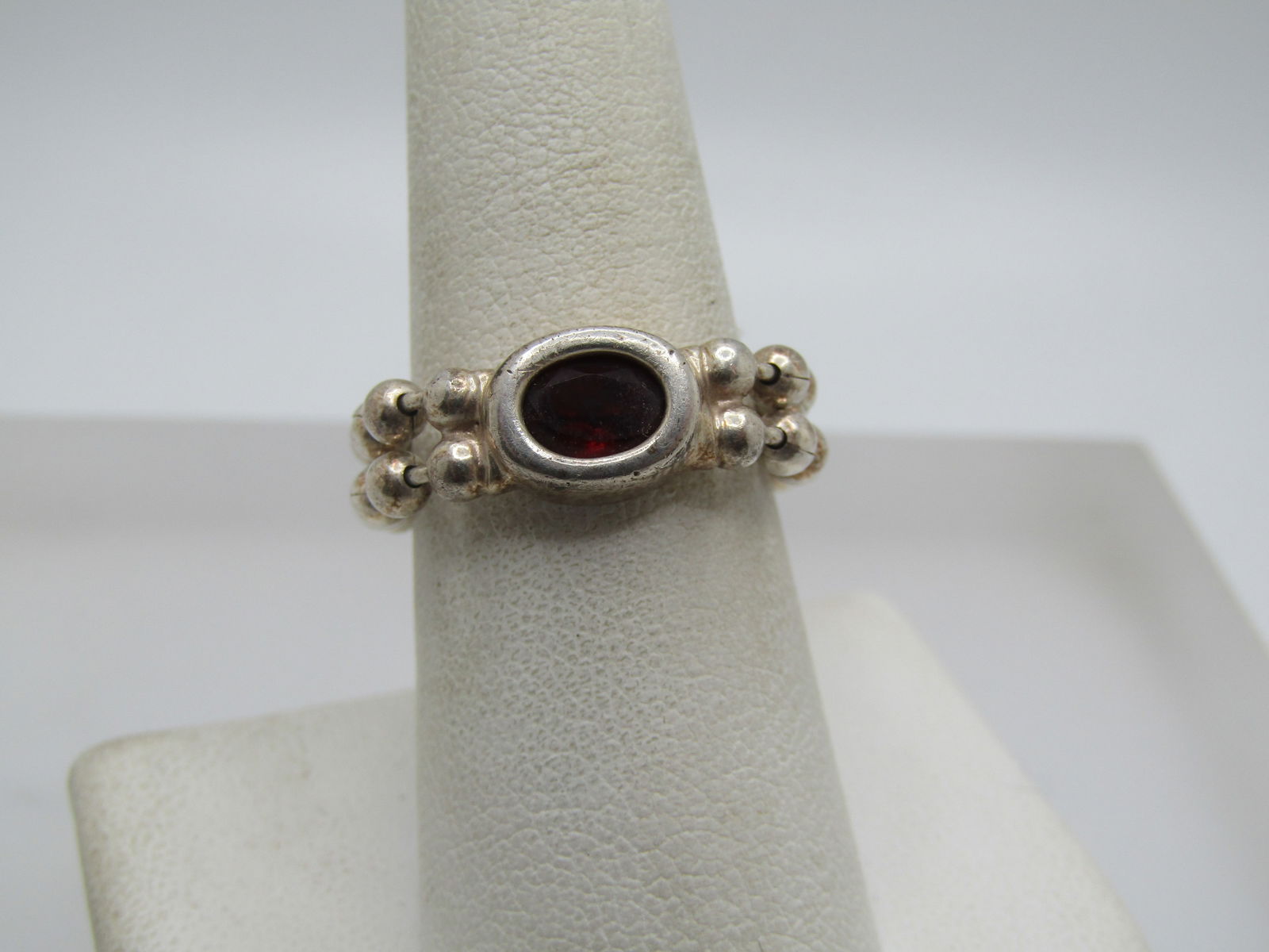 Vintage Sterling Garnet Chain Band Ring, Sz. 8.: Vintage Sterling Garnet Chain Band Ring, Sz. 8. trhis has a setting with a bezel around the garnet which is oval and appx. 8mm by 5.5mm. The band is two strands of beaded chain link (like a keychain