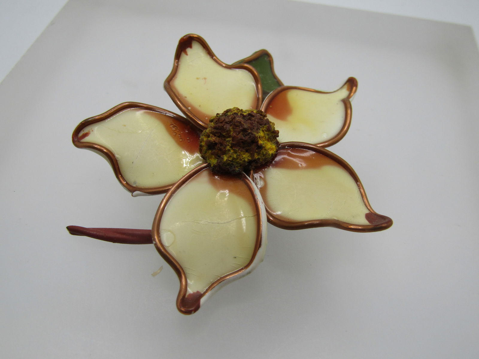 Vintage Hand Made Blossom Brooch, Magnolia, 1950's: Vintage Hand Made Blossom Brooch, Magnolia, 1950's. Five curved petals outlined in copper - they are creamy color with brown ccents, a green leaf and stem. 2.25" across with a yellow raised center