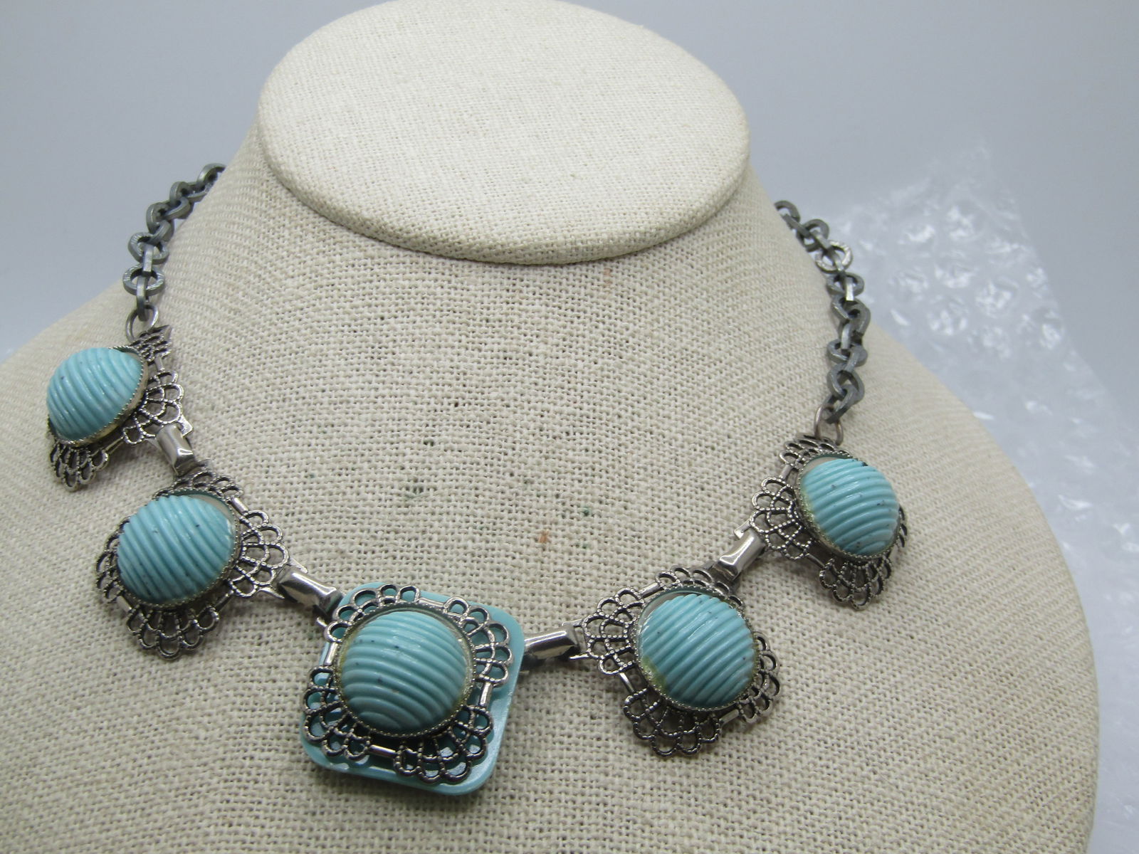 Vintage Faux Turquoise Filigree Necklace, 15", 1940's-1950's: Vintage Faux Turquoise Filigree Necklace, 15", 1940's-1950's. Five links with a filigree frame that sits under lucite ridged faux turquoise round cabochons that are appx. 13.5mm wide. Under the