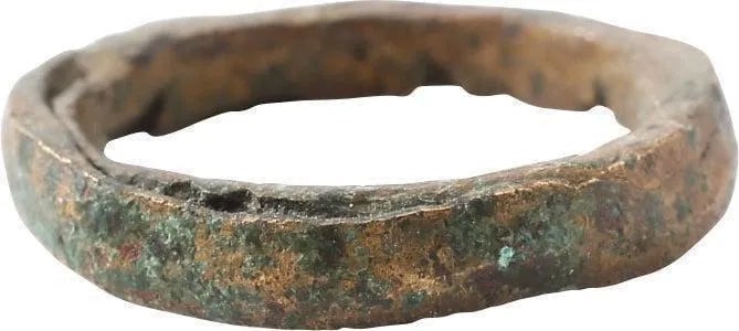 DOUBLY RARE VIKING COPPER WEDDING RING, SIZE 5 1/2: 10th-11th Century AD. 0.82' (20.8mm) outside diameter. Broad width band, 3.4mm, with low rounded face and cast with a central core which was laboriously removed to finish the ring for wear. In this ex