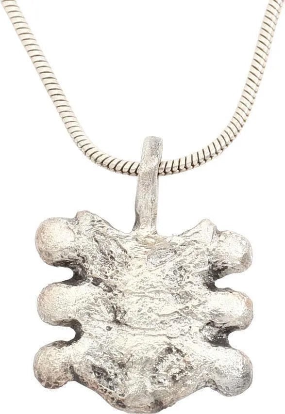 EUROPEAN NOBLE WOMAN'S NECKLACE PENDANT: C.100 AD. Over 3/4" height, silvered bronze as a symmetrical plume splay. Well detailed and excellent. The pendant of a noblewoman incorporating a motif from her family coat of arms identified her bot