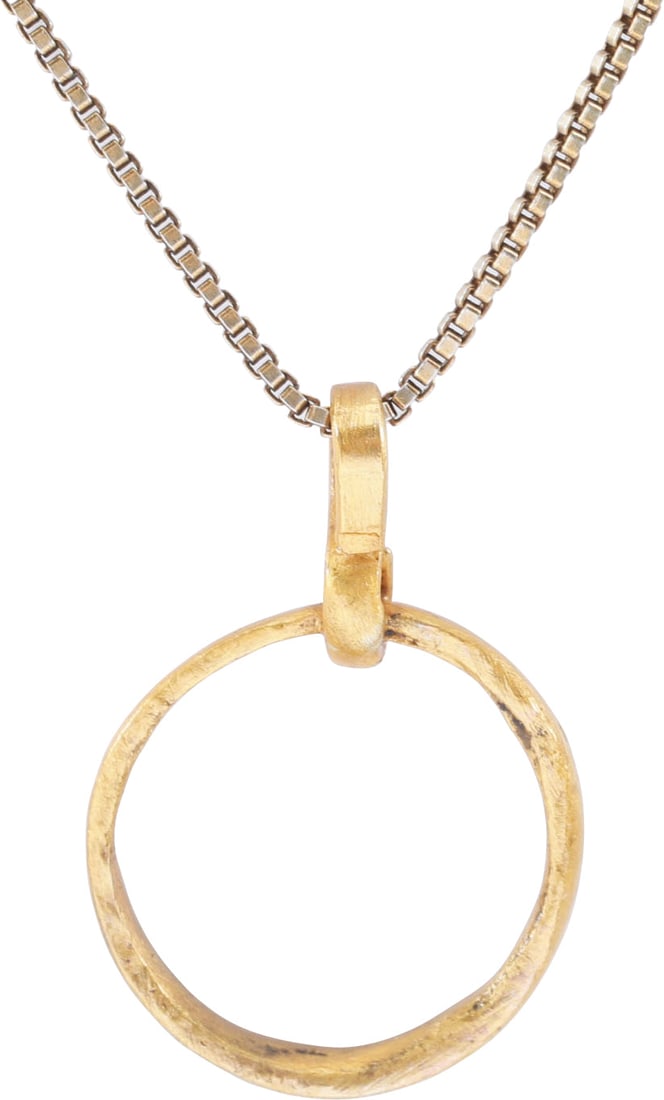 VIKING BEARD RING NECKLACE, 9th-11th CENTURY AD: Gilt bronze. Just over ½” (0.56”) in diameter. Circular, with flat face and edges. The use of beard ring jewelry by Viking warriors is well documented. Professionally refurbished for