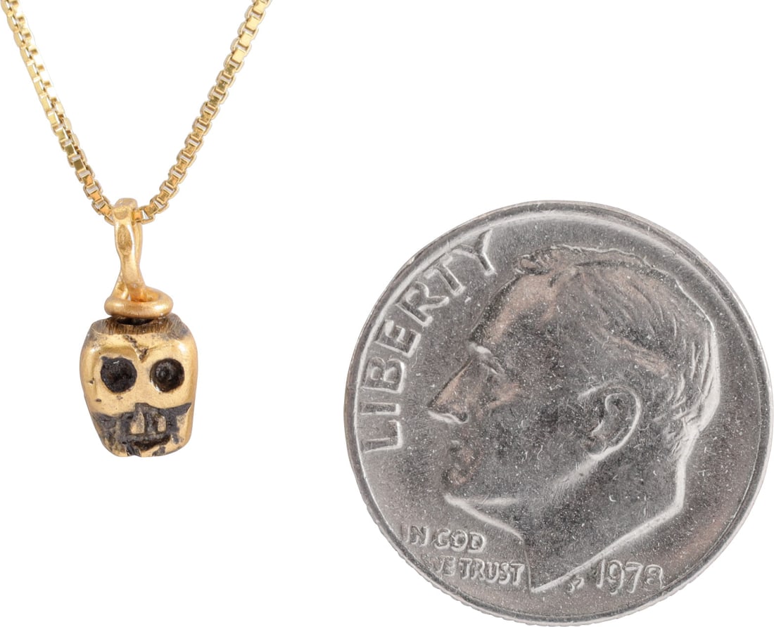 MEDIEVAL TIBETAN SKULL PRAYER BEAD NECKLACE: This small bronze bead, hand crafted about 1400-1550 was part of a Buddhist prayer ritual. It was strung along with others, each showing differences from hand work, to aid the devotee by focusing