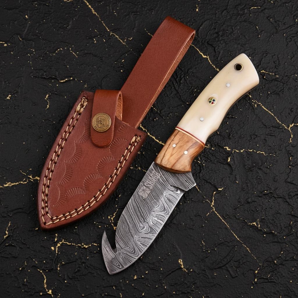 Damascus Steel Gut Hook Skinner Knife 9" Hand Forged with Bone Handle & Sheath: Title:Damascus Steel Gut Hook Skinner Knife 9" Hand Forged with Bone Handle & SheathDescription:This is a custom hand forged hunting knife, crafted from high quality, pattern welded Damascus steel.