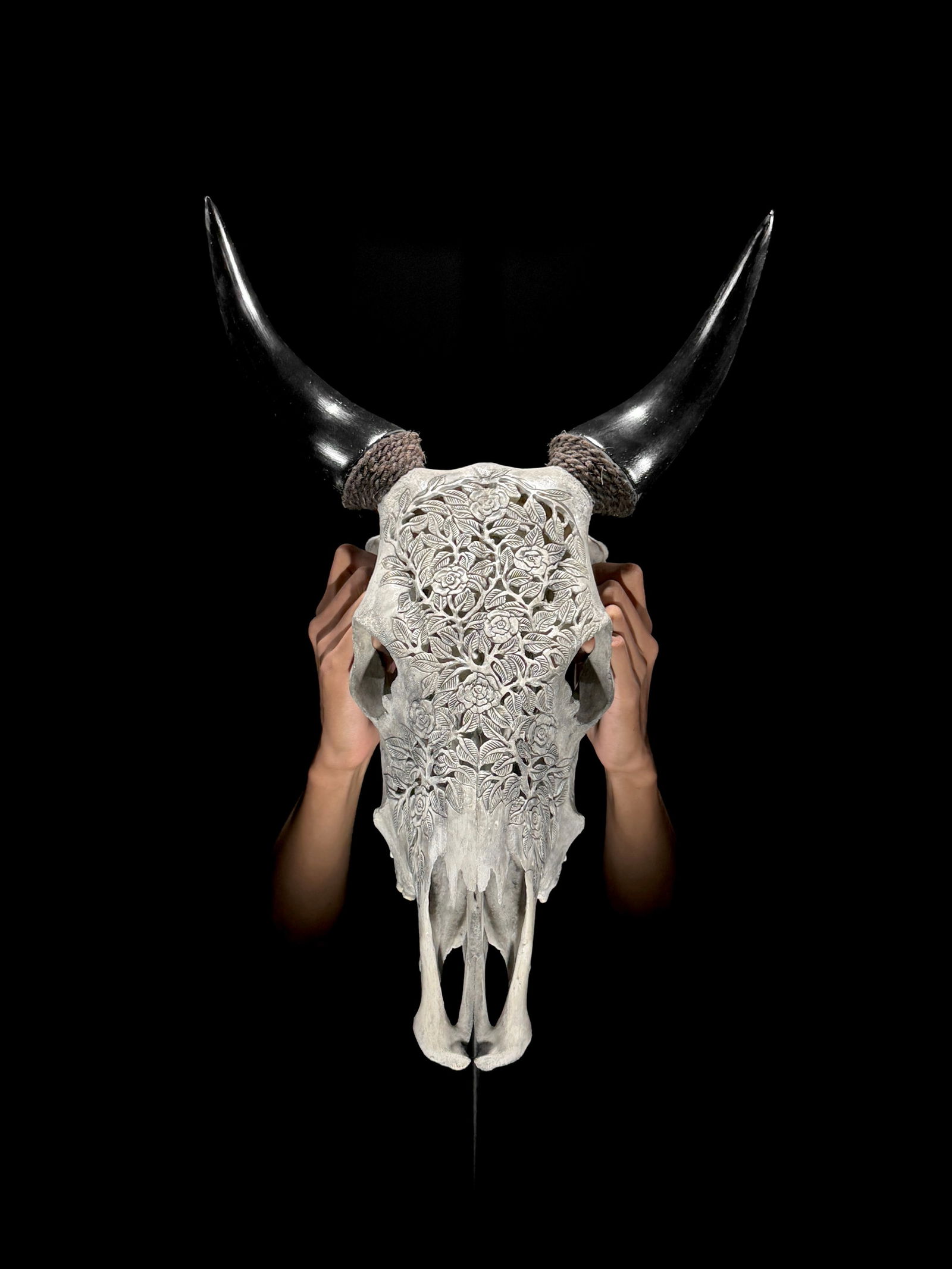 Carved grey cow skull - Roses Motif: Title: Carved grey cow skull - Roses MotifMaker:UnknownOrigin: IndonesiaDate/Period:2024Materials:Bos Taurus, Bone, HornDimensions:Length: 52 cm / 20.4 inches Width: 39 cm / 15.3