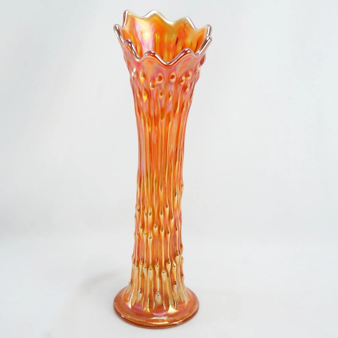Swung Vase Carnival Glass Circa 1910: Title:Swung Vase Carnival Glass Circa 1910Size:3 1/2 in (8.9 cm) diameter x 11 1/2 in (29.2 cm) tall.Description:A swung vase in marigold carnival glass with a textured pattern that resembles tree