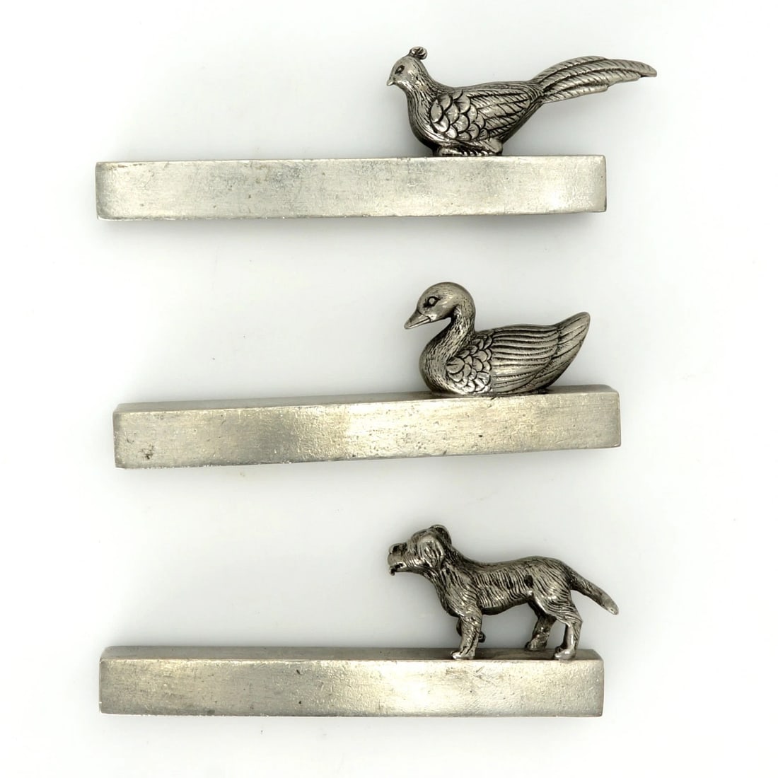 Three Pewter Knife Rests Duck, Pheasant, Dog: Title:Three Pewter Knife Rests Duck, Pheasant, DogSize:Each measures approximately 2 7/8 in (7.3 cm) long x 1/2 in (1.3 cm) wide x 2 in (5.1 cm) tall.Description:A set of three French pewter knife