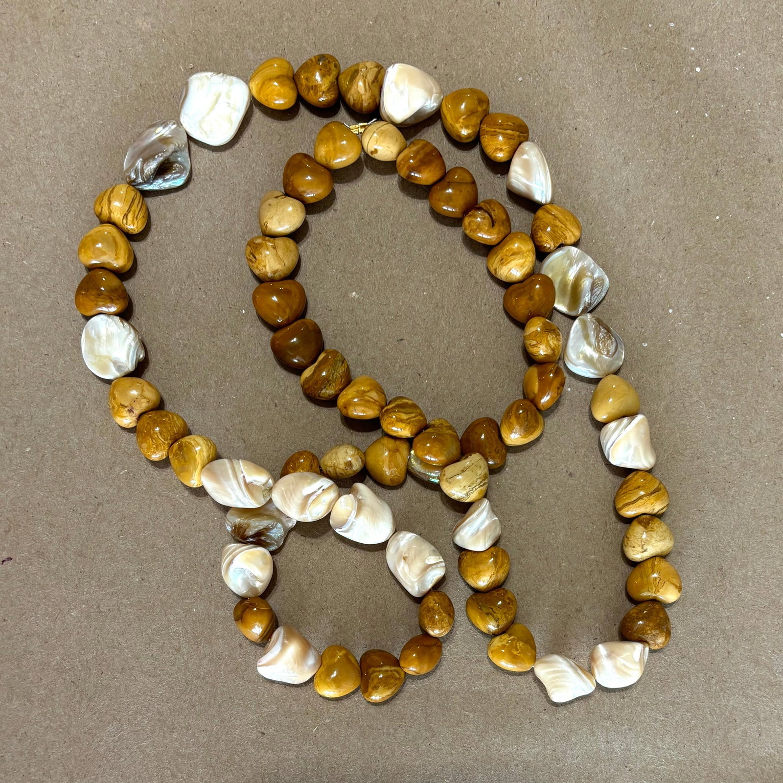 Agate & Clam Shell Bead Necklace: Title:Agate & Clam Shell Bead Necklace Description:Fun beads to hang stuff on. These heart-shaped Agates looklike wood, and they go nicely with these ivory, natural cut Clam Beads. This looks super wi