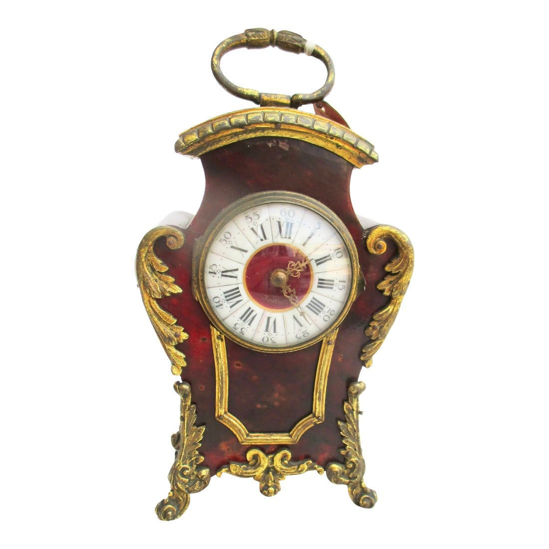 Tiffany Ormolu and Burl Desk Clock Circa 1900-1910: Tiffany & Co. New York desk clock with burl veneer and ormolu trim. Regency style with high, wide shoulders and elaborate scrolling trim on the corners, feet, and crown. The Original key is included.