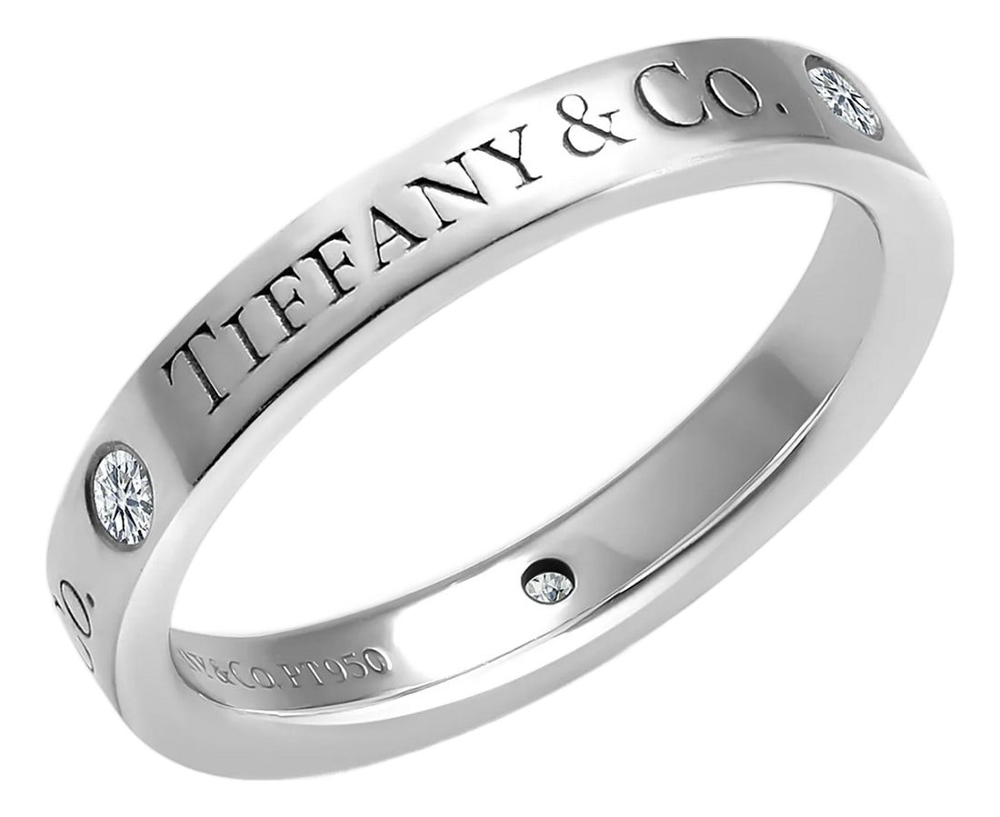 Tiffany Co Vintage Platinum Diamond 0.15 Carat Band No 85 Finger Size 5: A timeless treasure from the house of Tiffany & Co., this vintage platinum band features a delicate row of diamonds weighing approximately 0.15 carats, offering understated sparkle and enduring