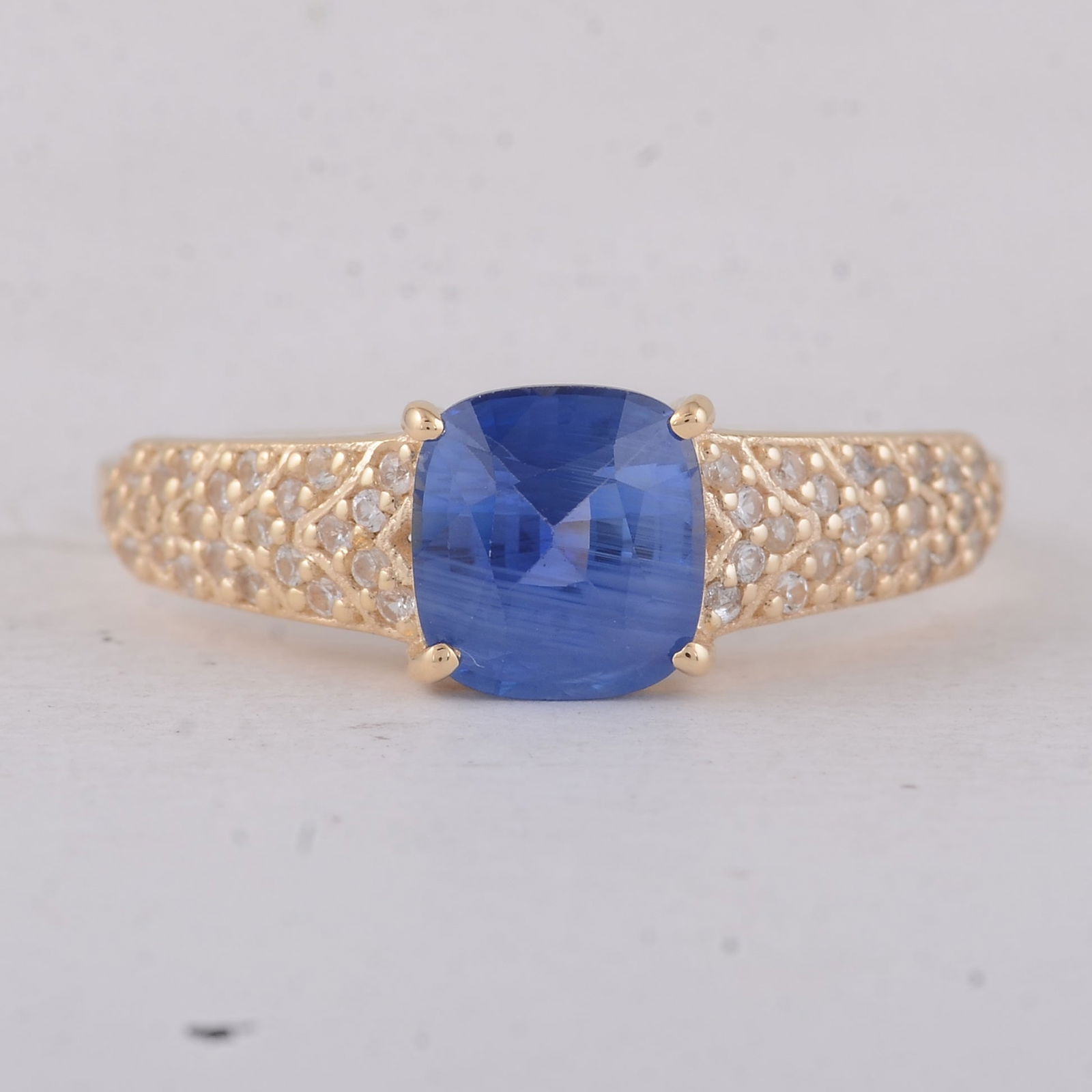 1.78 Ct Cushion Sapphire 9K Gold Ring: 1.78 Total Carat Sapphire 9K Gold Ring Specifications - Total Weight 2.24 g - Center Gemstone Sapphire - Gemstone Carat Weight 1.57 Carats - Gemstone Measurements 6.80X6.30X4.10 mm - Additional Gemsto