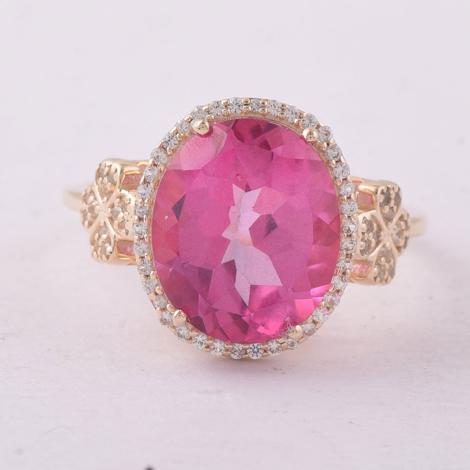 5.73 Ct Oval Pink Topaz 9K Gold Ring: 5.73 Total Carat Pink Topaz 9K Gold Ring Specifications - Total Weight 3.336 g - Center Gemstone Pink Topaz - Gemstone Carat Weight 5.49 Carats - Gemstone Measurements 12X10 mm - Additional Gemstones