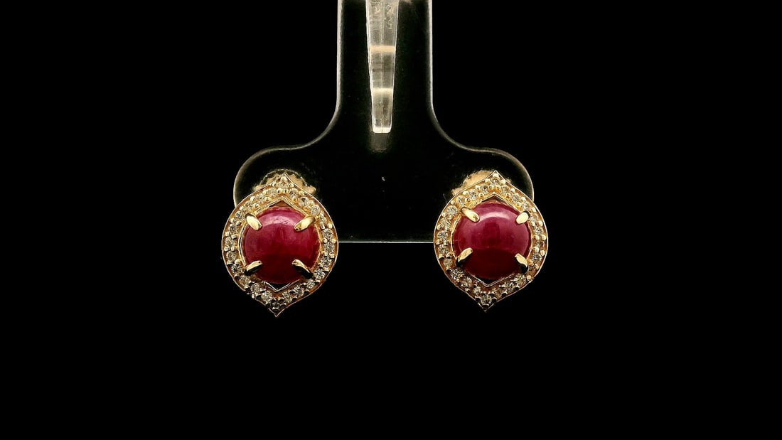 2.91 Ct Round Ruby 9K Gold Earrings: 2.91 Total Carat Ruby 9K Gold Earrings Specifications - Total Weight 1.946 g - Center Gemstone Ruby - Gemstone Carat Weight 2.71 Carats - Gemstone Measurements 6 mm - Additional Gemstones White