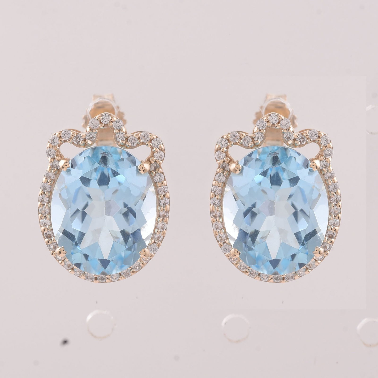 9.24 Ct Oval Blue Topaz 9K Gold Earrings: 9.24 Total Carat Blue Topaz 9K Gold Earrings Specifications - Total Weight 3.686 g - Center Gemstone Blue Topaz - Gemstone Carat Weight 8.94 Carats - Gemstone Measurements 11X9 mm - Additional