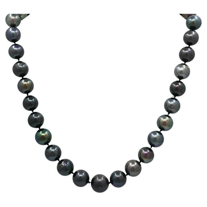 Tahitian Pearl Strand Necklace 14k Gold Clasp: About the Item Elegant strand of genuine Tahitian black pearls, expertly knotted and finished with a 14k white gold ribbed ball clasp. The graduated pearls measure approximately 1/2 inch to 7/16 inch