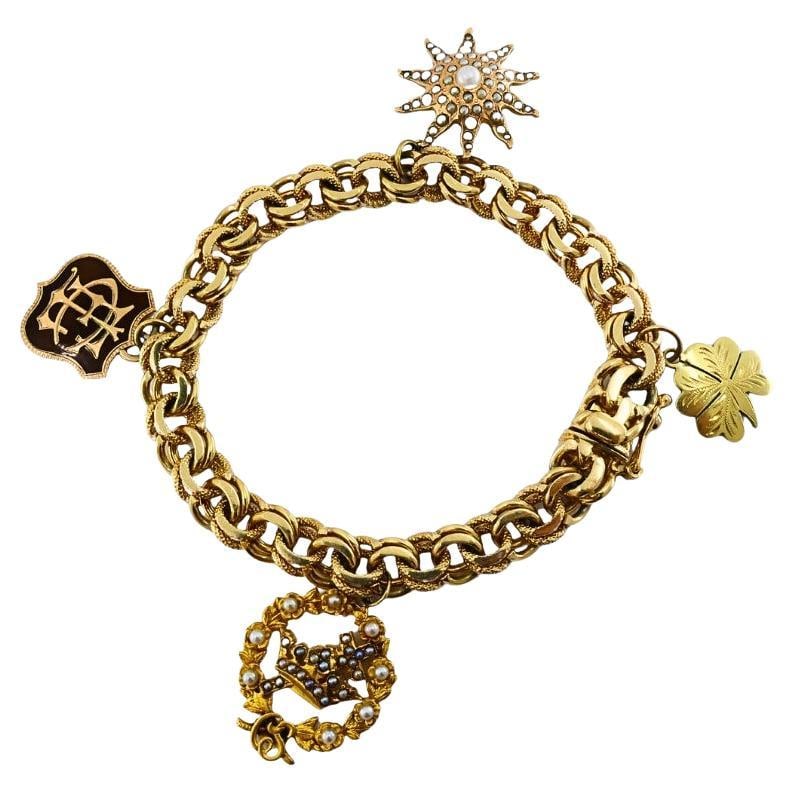 Victorian 14k Gold Link Bracelet Enamel Pearl & Engraved Charms: About the Item This exquisite Victorian charm bracelet is crafted in 14k gold, featuring a substantial double link chain measuring approximately 7 inches in length and secured with a classic box