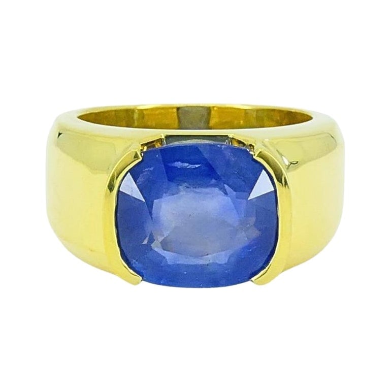 Burma Natural Sapphire 18K Gold Ring GIA Report: About the Item This exquisite ring features a stunning natural sapphire of Burmese origin, renowned for its rich, vibrant blue hue. The sapphire, weighing approximately 6.99 carats, is cut into a cush