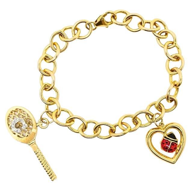 14k Gold Link Charm Bracelet Vintage Jewelry: About the Item A gold link charm bracelet featuring two playful charms on a classic oval-link chain. The bracelet is made of uniformed links with a smooth finish and secure lobster clasp. One charm