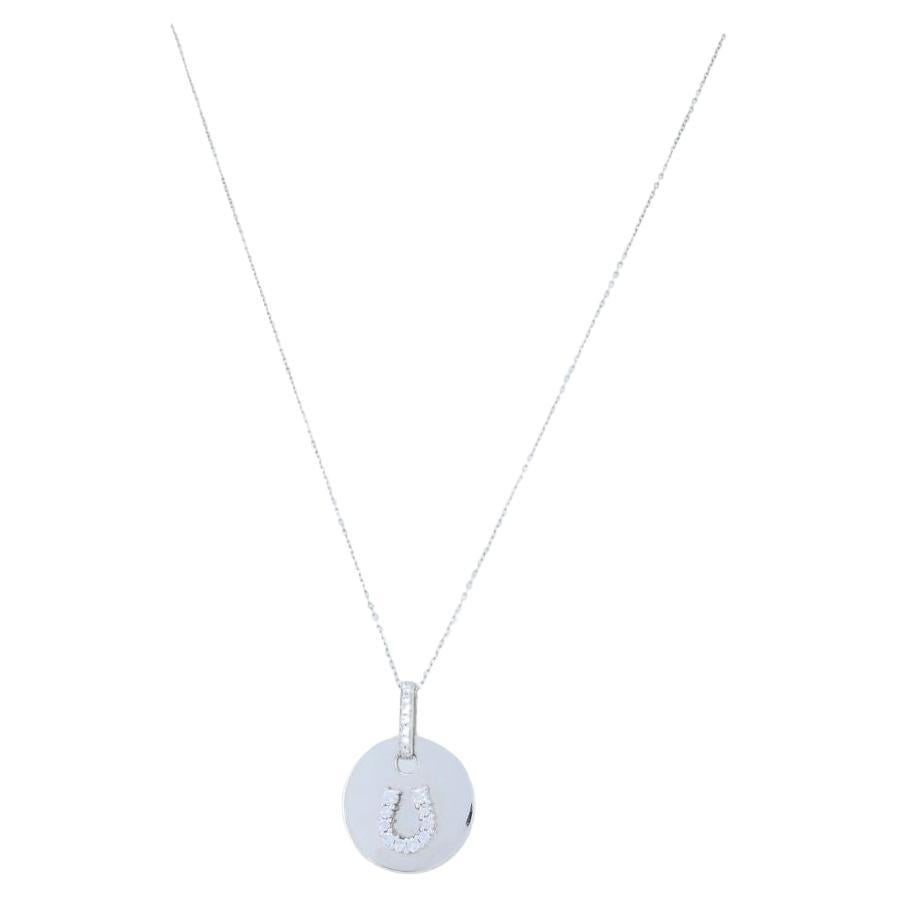 Vintage 18k White Gold Horseshoe Diamond Pendant Necklace: About the Item This circa 1980s necklace features a diamond horseshoe pendant crafted in 18k white gold, suspended from a 14k white gold chain. The round pendant is stamped “PRF” and