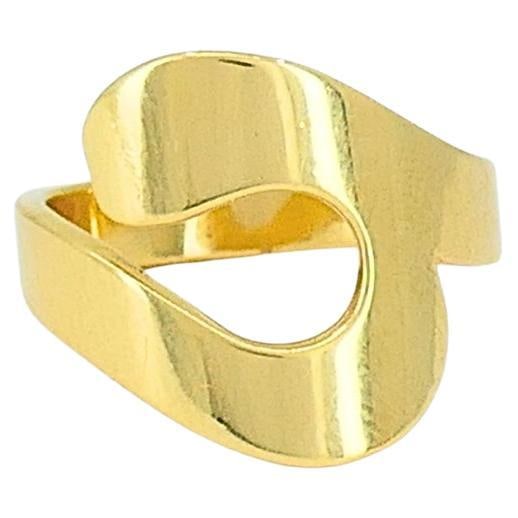Cartier Paris 18k Gold Modernist Ring: About the Item A striking example of Cartier’s mastery in modern design, this Cartier Paris ring is crafted in 18k gold. The bold, sculptural form features a fluid, openwork motif that wraps