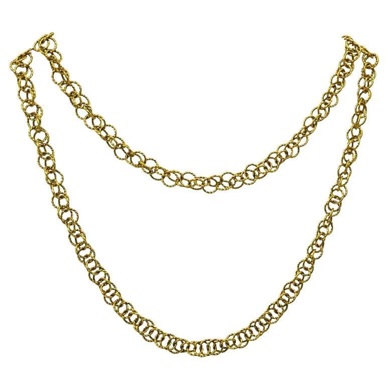 18k Gold Twisted Link Chain Necklace French Jewelry: About the Item An 18k gold twisted link chain necklace, French made. Each link is formed by a small ring threading through and around a group of coil-like rings. This design creates a layered look