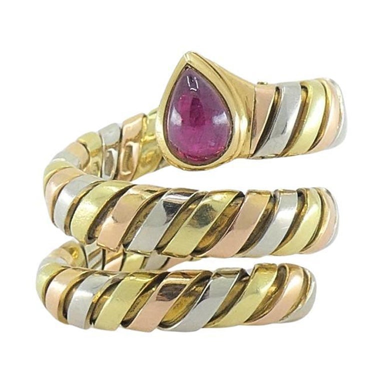 Bvlgari Bulgari Serpenti Tubogas Tricolor 18k Gold Ruby Ring: About the Item The Bvlgari Serpenti Tubogas Gold Ruby Ring is crafted in 18k gold, features alternating sections of yellow, rose, and white gold, creating a visually dynamic and luxurious tricolor