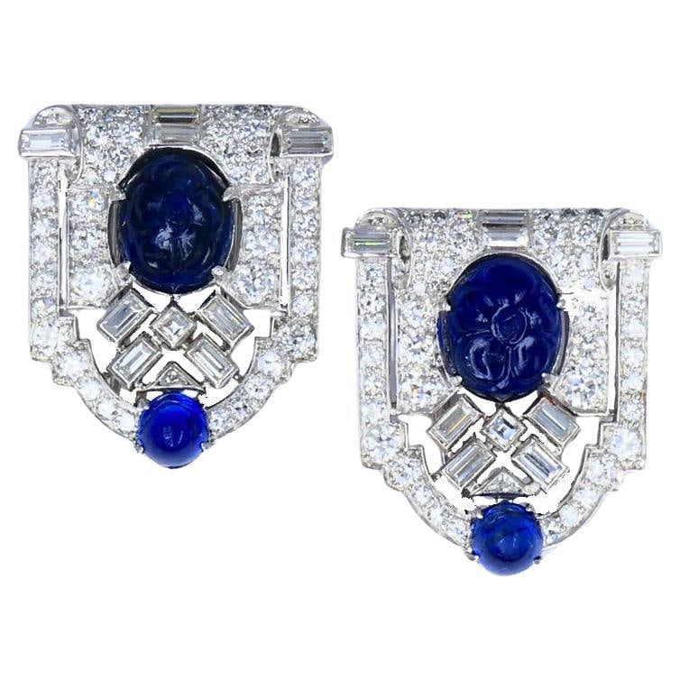 Vintage French Platinum Diamond Clips Carved Sapphire Estate Jewelry: About the Item A pair of vintage French platinum diamond clips, featuring carved sapphire. The clips design is focused on symmetry and strong lines. At the center of each piece there is a carved blue