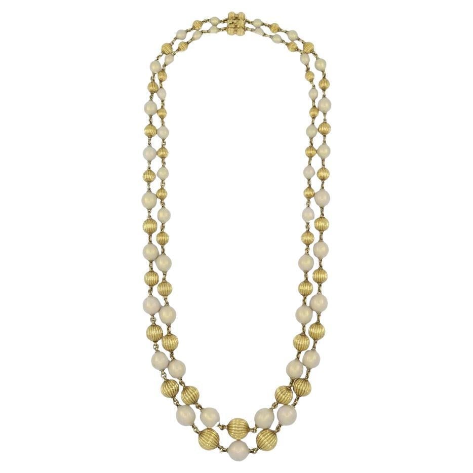 Vintage Tiffany & Co. 18k Gold Enamel Beaded Necklace: About the Item This vintage Tiffany & Co. double strand beaded necklace is crafted in 18k yellow gold with alternating white enamel beads. The necklace features a graduated design, with bead sizes inc