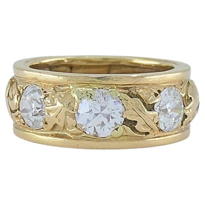 Vintage Diamond Band 14k Gold Leaf Motif Ring: About the Item This vintage 14k gold band features a detailed leaf motif that makes a textured backdrop for its diamond accents. Three larger diamonds are spaced evenly across the center of the ring.