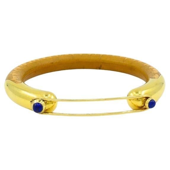 Rare Elsa Peretti for Tiffany & Co. Gold Lapis Lazuli Rattan Bracelet: About the Item Rare Elsa Peretti for Tiffany & Co. rattan bracelet, featuring 18k gold and lapis lazuli. The bracelet brings together a warm, natural rattan core with sleek 18k yellow gold elements.
