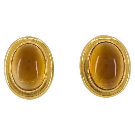 Bvlgari Bulgari Citrine Cabochon Earrings 18k Gold: About the Item Each earring features an oval-shaped cabochon citrine set in a smooth gold bezel. The citrine has a mellow amber hue with a polished finish. The gold frames are slightly domed and