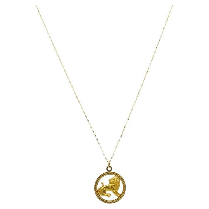 Vintage Leo Zodiac 18k Gold Pendant 14k Gold Chain Necklace: About the Item A vintage Leo zodiac pendant made of 18k gold featuring a 14k gold chain necklace. This vintage zodiac pendant features a raised lion at the center of a circular frame. The