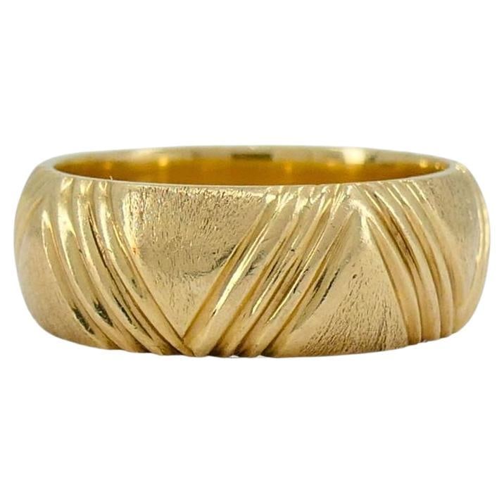 1950s Cartier 14k Gold Brushed Band Ring sz 7: About the Item This Cartier ring from the 1950s is crafted in 14k gold and weighs 8 grams. It features a brushed gold design with an engraved pattern of intersecting lines wrapping around the band.