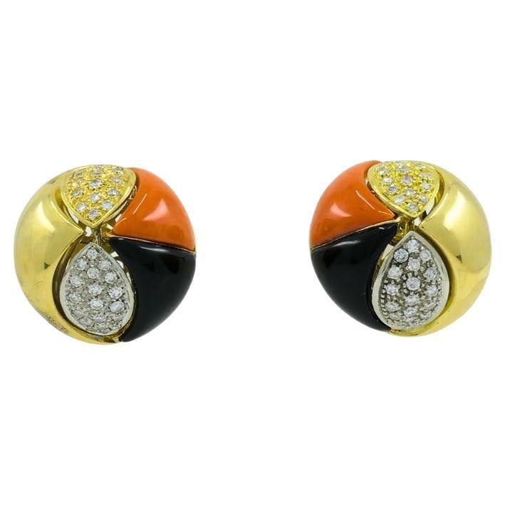 Vintage Tiffany & Co. Coral Onyx Earrings Diamond Gold Estate Jewelry: About the Item A rare pair of vintage Tiffany & Co. earrings made of 18k gold, black onyx, coral, accentuated with diamonds. These button earrings boast a unique design comprises a gold part, a