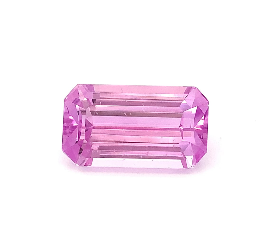 29.30 Carat Fuchsia Pink Kunzite Emerald Cut Gemstone From Afghanistan: Details SKU Uet Dimensions (mm) 22.8 x 13 x 11 mm Weight (cts) 29.6 Treatment Heat Treatment Shape Emerald Type Faceted Clarity VVS Colours Description Specifications: • Weight