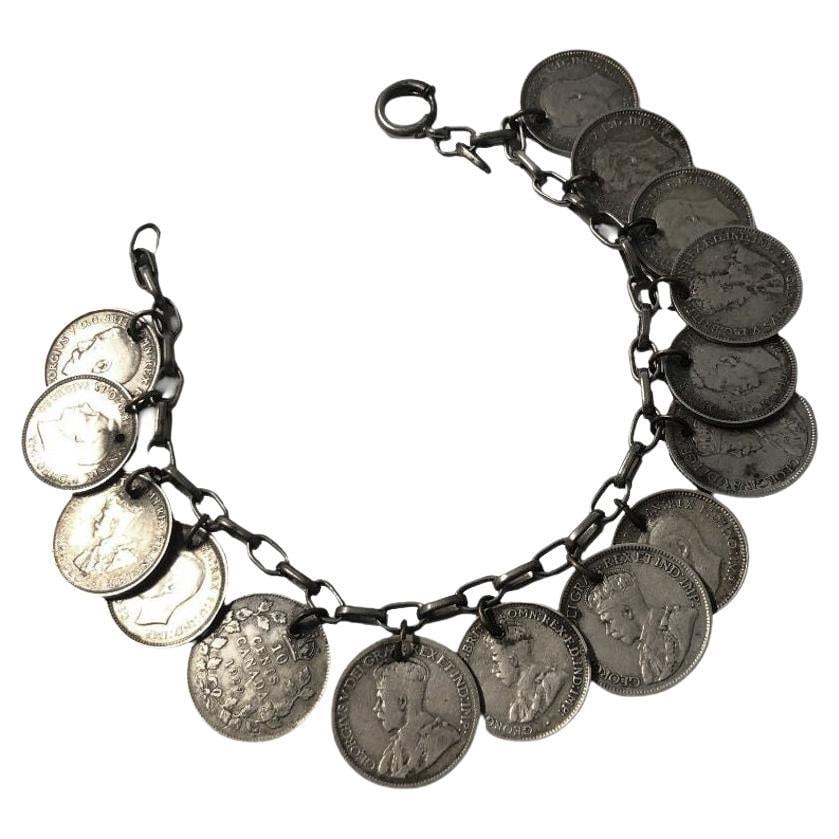 WWII era Canadian, English & Australian Solid Silver Coin Charm Bracelet: Title: WWII era Canadian, English & Australian Solid Silver Coin Charm Bracelet Description: Handmade WWII era silver coin bracelet featuring 15 silver coins (3 pence to 10-cent coins) from Canada, Au