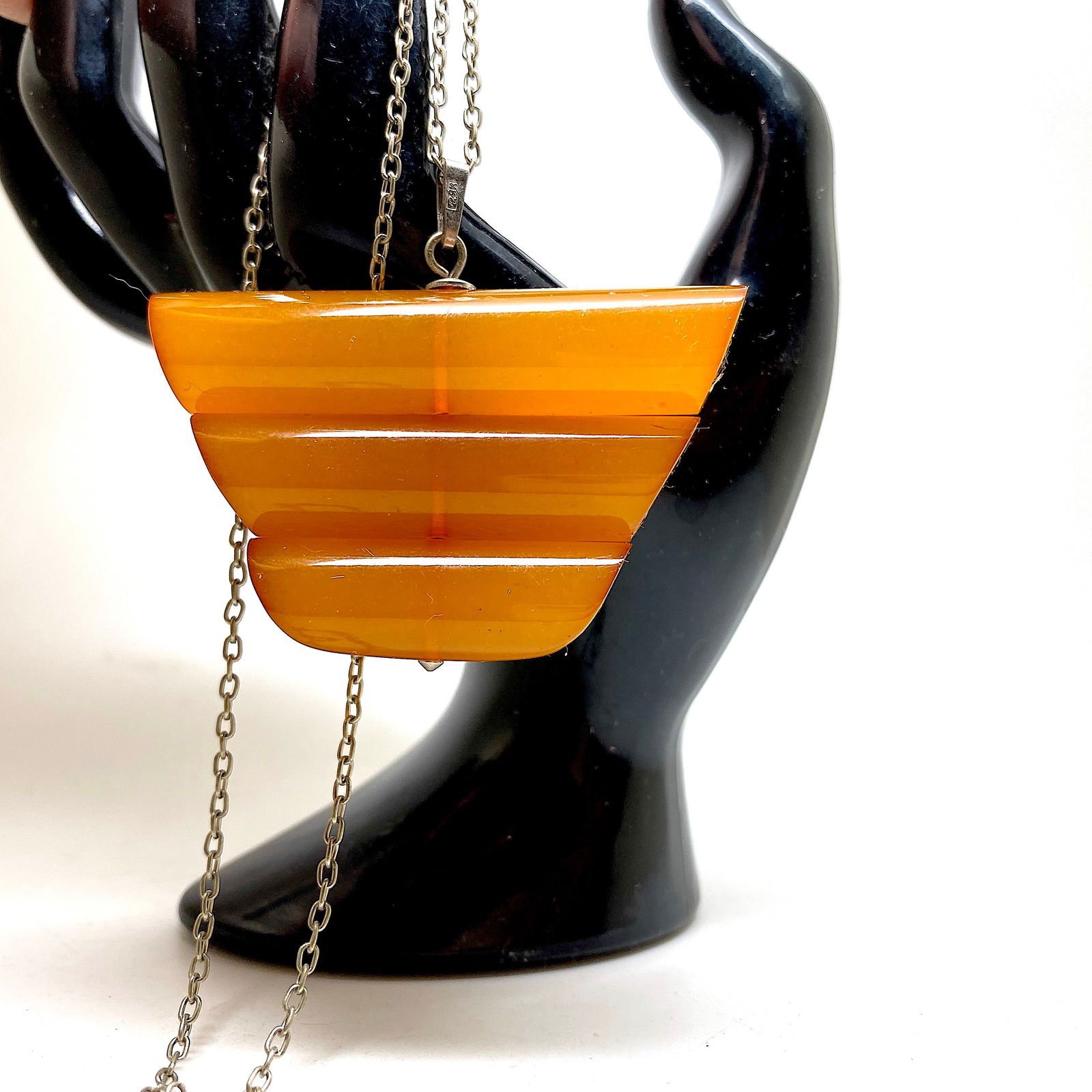 Antique Amber Pendant with chain, shaped like an Ornament: Title:Antique Amber Pendant with chain, shaped like an Ornament Metal:Metal Gemstone:Amber Weight:20.9 g Size:Size: 59.0 x 50.0 x 13.0 mm Size: 2.323 x 1.969 x 0.512 inches Made of:(Reconstituted Ambe