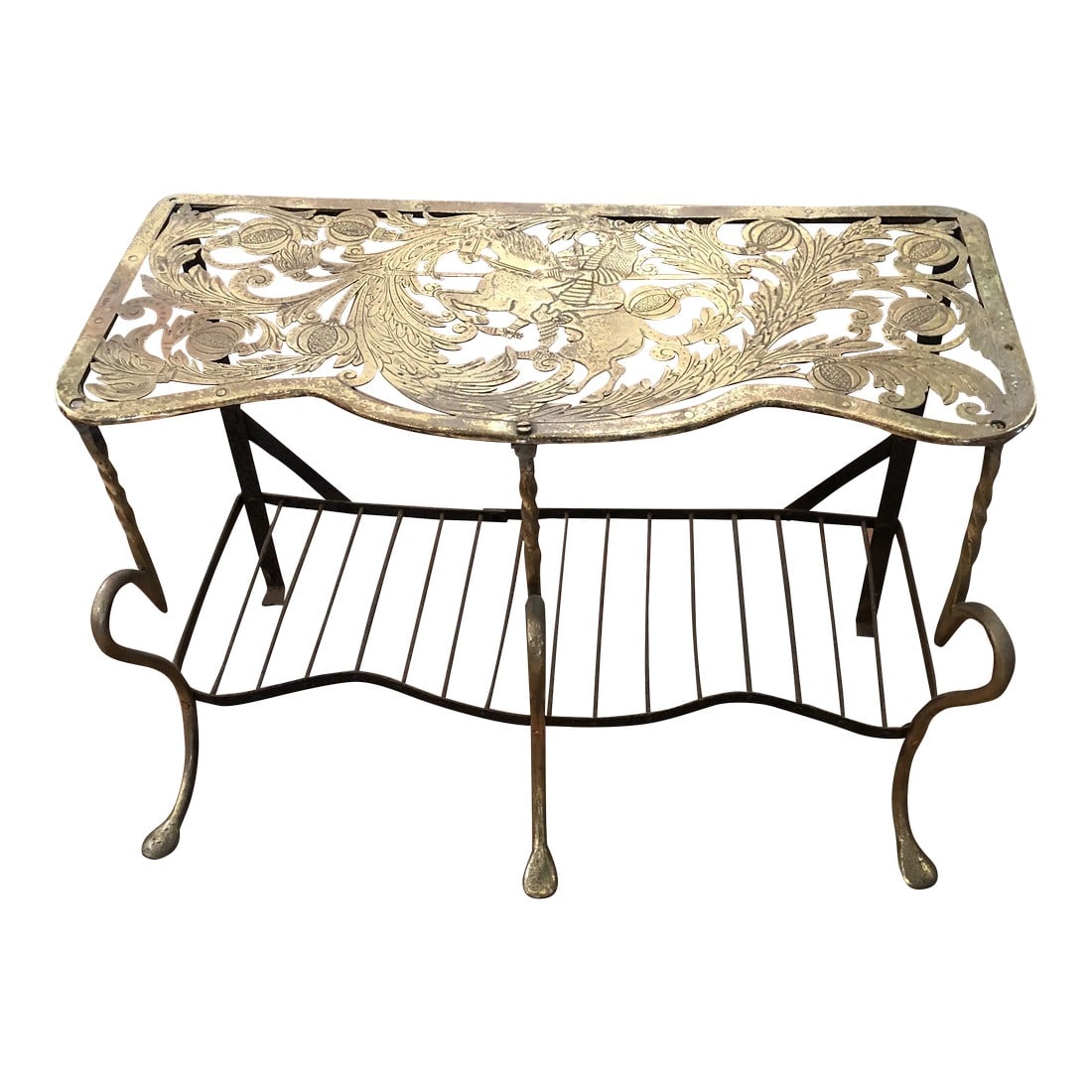 Antique 19th Century Engraved and Intricately Cut Brass Trivet: Beautiful 19th century elaborately cut and engraved brass trivet having a horse and rider centrally depicted on top, a lower shelf 4" from floor, scalloped front edge and lovely cabriole twisted iron