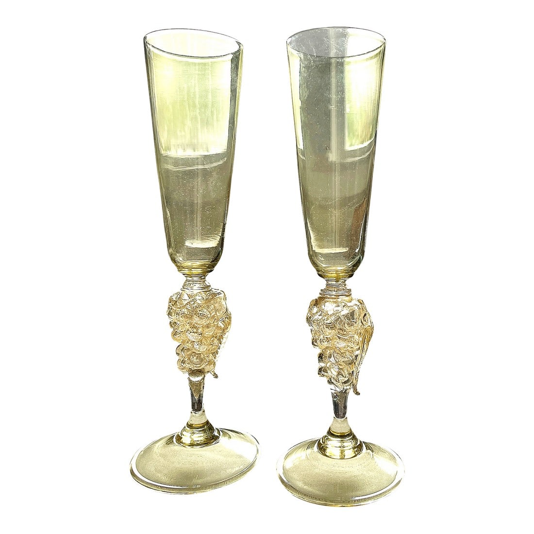 Vintage 1970s Signed Nason Moretti Murano Champagne Flutes With Grape Cluster Stems Gold Infused - A: An exquisite pair of signed Murano champagne flutes by Nason Moretti, one of Venice's most celebrated glassmakers. Each flute features a tall, tapered bowl in a delicate golden hue, rising from a