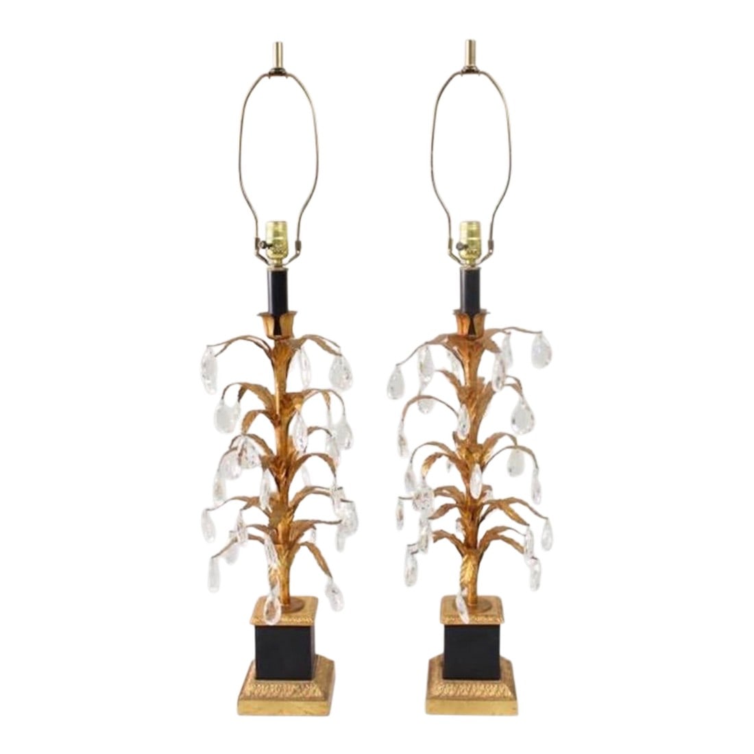 1950s Foliate Italian Tole Hollywood Regency Gold Gilt and Black Pair of Lamps With Crystals - a Pai: Pair of Italian Hollywood Regency Gilt Tole Lamps. Fabulous matching pair of lamps have gilt metal stems embellished with leaves, with faceted glass crystal dangling throughout. Bases are metal
