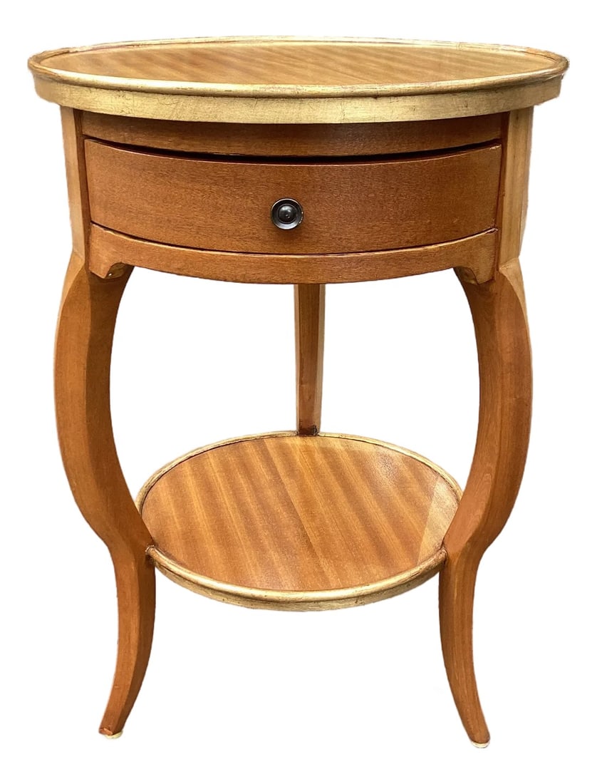 Vintage Round Mahogany Two-Tier Side Table With Drawer - Regency Style Accent Table: A charming vintage round accent table crafted in warm mahogany with beautifully grained, book-matched veneer to the top and lower shelf. The gently curved apron houses a single drawer with a classic r