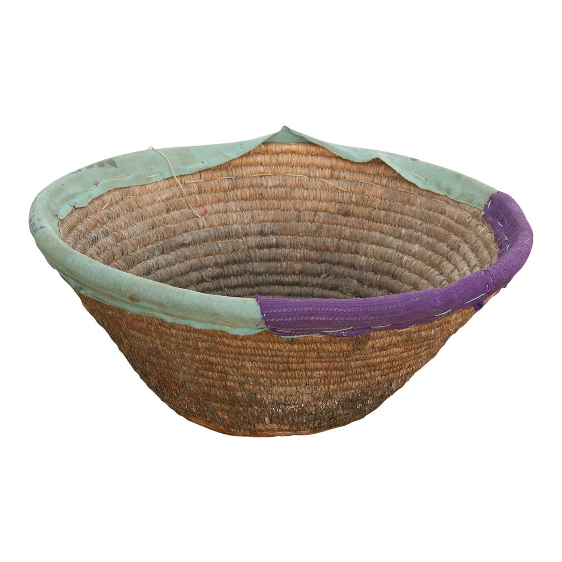 Vintage Nomodic Harvest Bowl W/Colorful Textile Rim: This nomadic harvest bowl is a fascinating representation of traditional craftsmanship meeting globalized trade. Like many utilitarian baskets of its kind, it was meticulously hand-woven to serve as