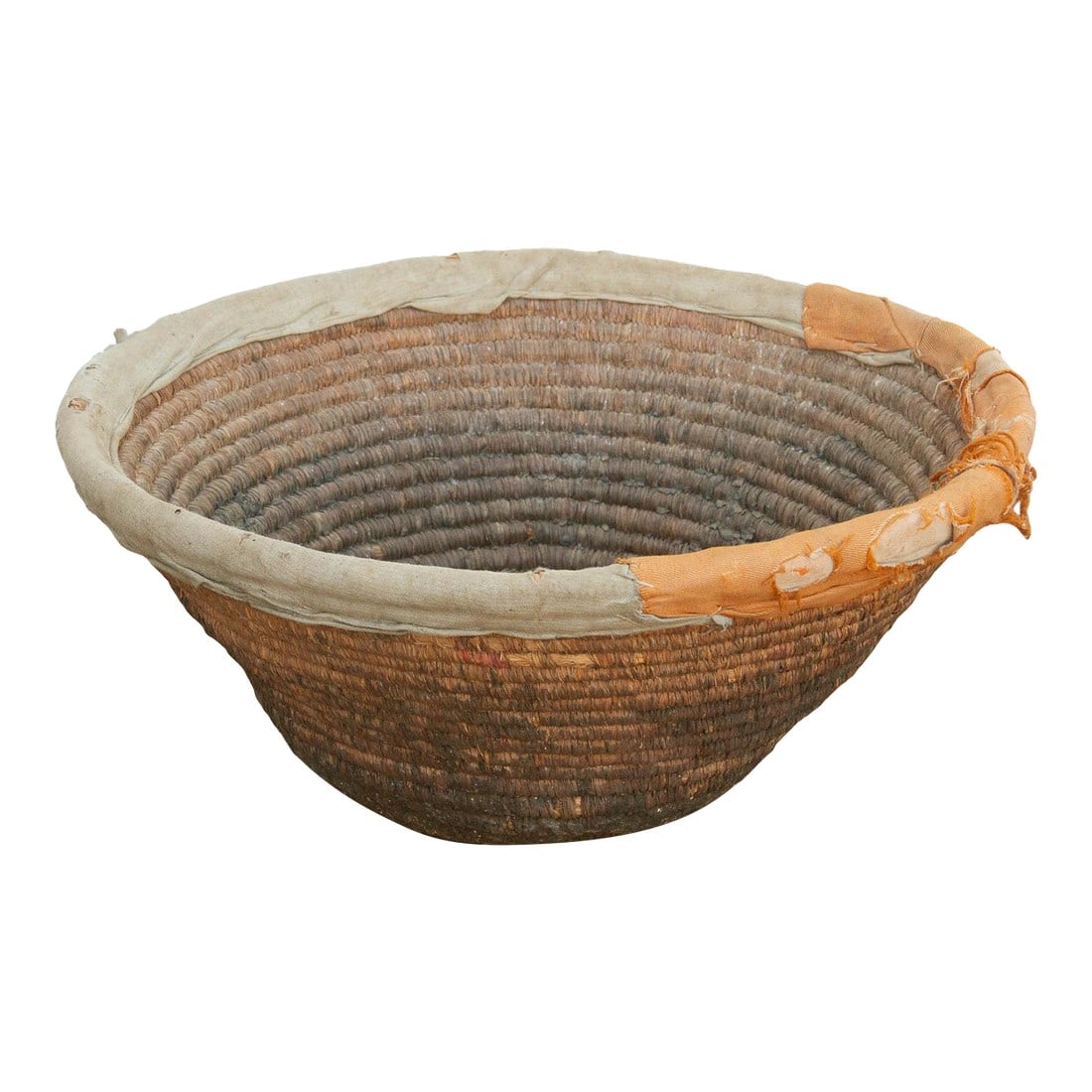 18" Dm Harvest Basket With Textile Rim & Mud Base: This deeply coiled nomadic harvest bowl perfectly exemplifies the marriage of rural resourcefulness and everyday utility. In traditional agrarian communities, deep, sturdy baskets like this were the a