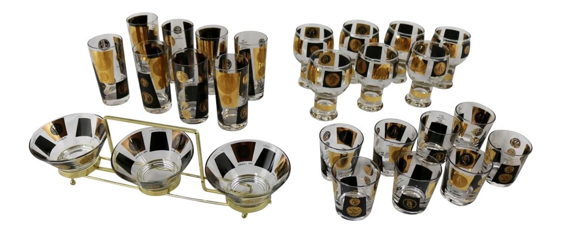 Cera Black & Gold Coin Design Barware and Glasses - Set of 26: Very large extensive set of coin mid-century modern barware and glasses by Cera. The set consisting of eight highball glasses, eight 5-ounce rocks glasses, seven footed beer glasses, and three nut