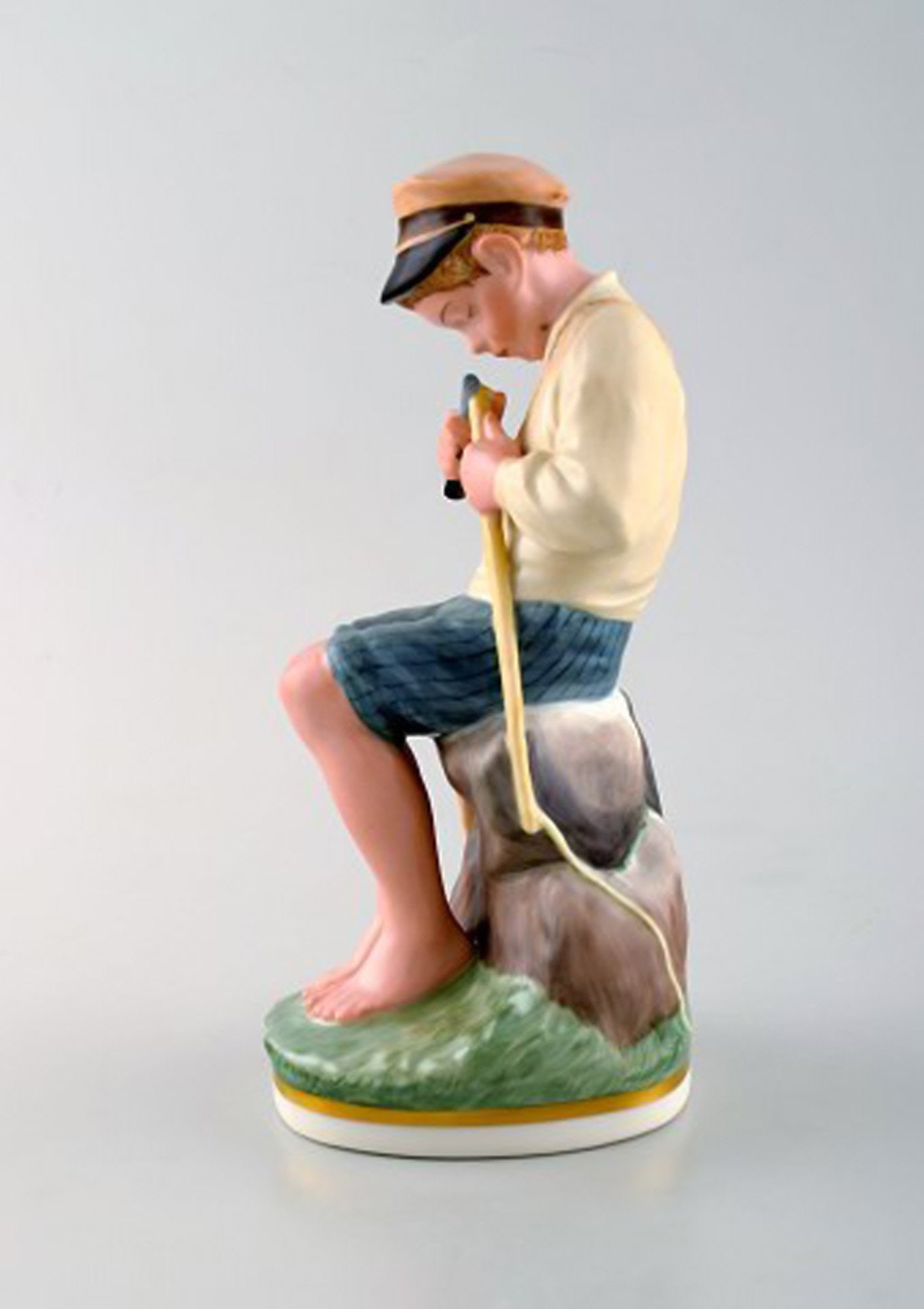 Royal Copenhagen porcelain figurine in high quality over glaze. Young boy. Model number 905. Dated - 2
