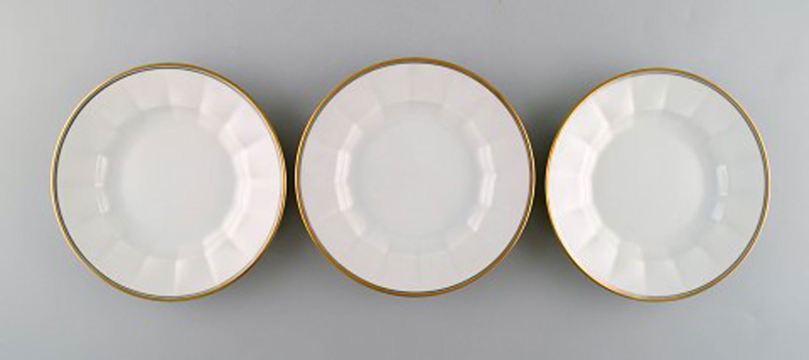 Royal Copenhagen. Three porcelain plates with gold border. - 2