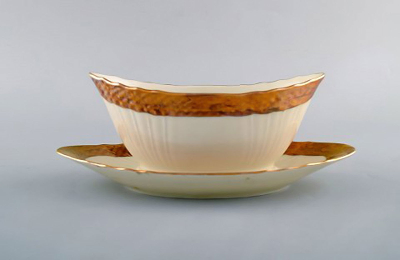 Royal Copenhagen porcelain sauce boat with floral motifs and gold border. Mid 20th century. Two - 2
