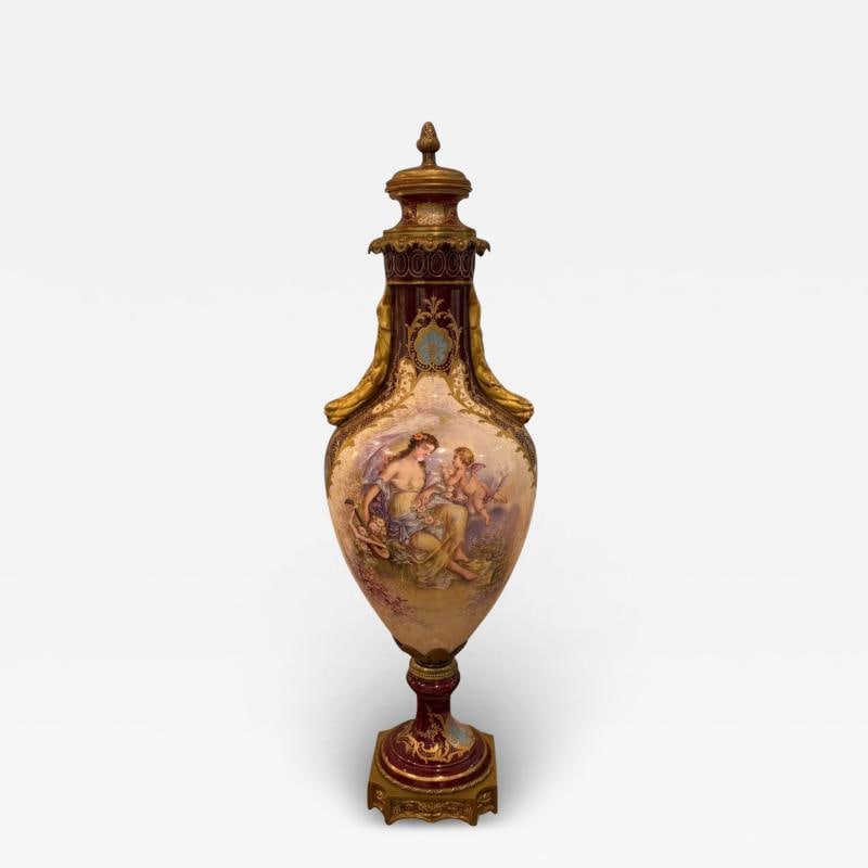 Sevres, Porcelain, Gilt Metal, Vase with Cherub and Maiden, France, 19th C.: Title: Sevres, Porcelain, Gilt Metal, Vase with Cherub and Maiden, France, 19th C. Description: Sevres Burgundy Ground Gilt Metal Mounted Two Handle Vase with Matching Lid This oval shaped vase featur
