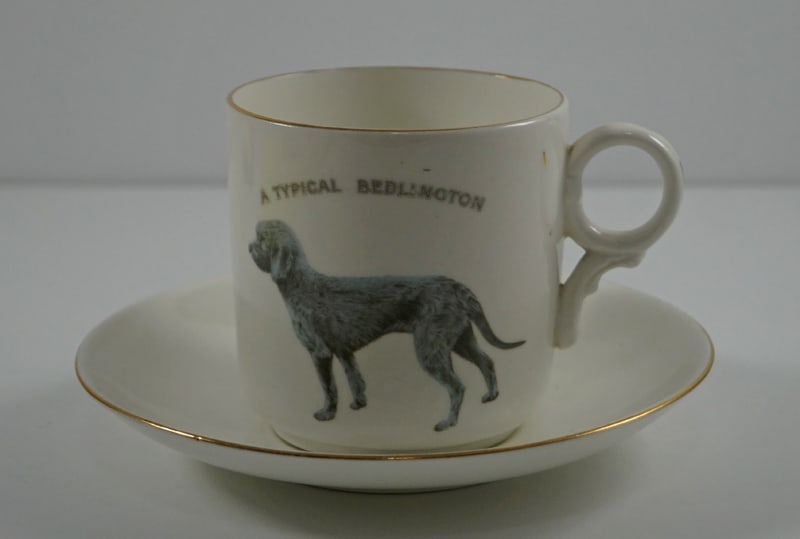 Bedlington Terrier Dog China Cup Saucer Dated 1911: Title: Bedlington Terrier Dog China Cup Saucer Dated 1911Dimension: Cup – 3 ¼” tall x 3 1/8” dia., Saucer – 6 ¼” dia.Date: Dated 1911.Additional Information: